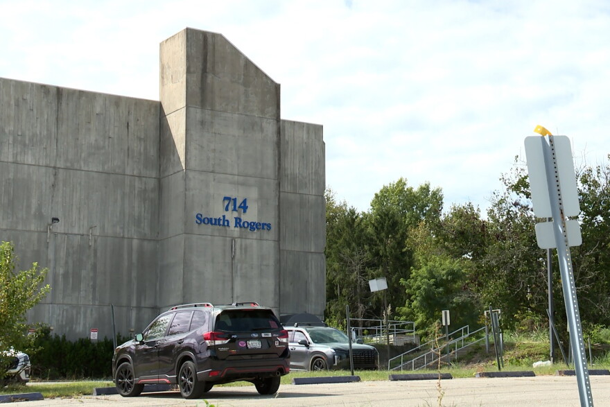 A concrete building and parking lot