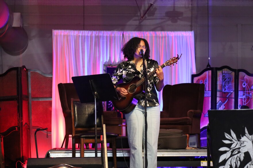 Jess Goodlet performing at Majestic Coffee House while artist Dyri Rattinglingourd paints nearby. Photo by Allison Diaz.