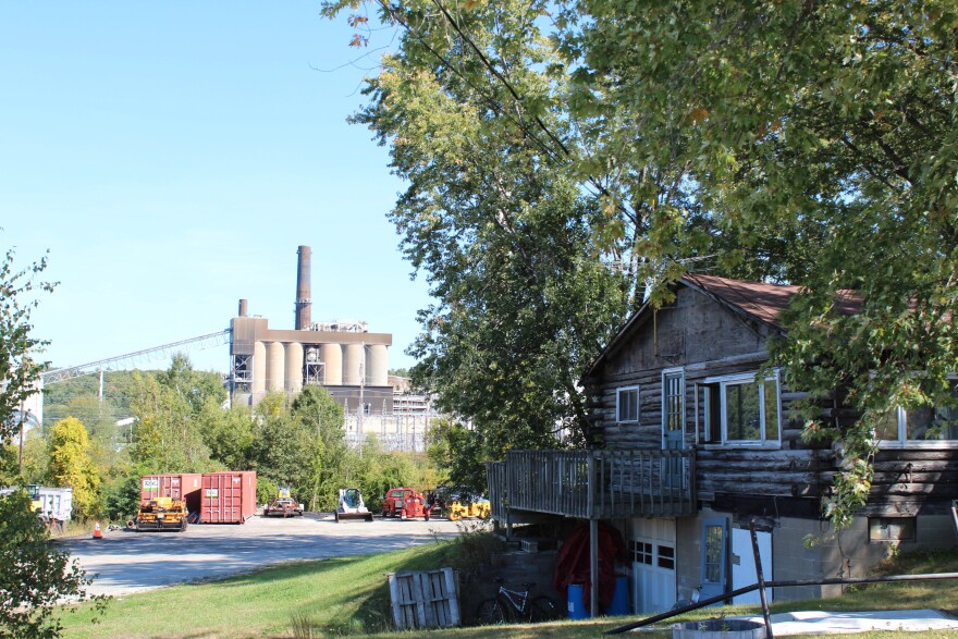 Merrimack Station sits between River Road and the Merrimack River in Bow, near houses and industrial offices.