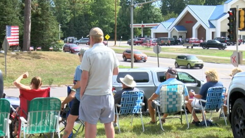 Northwood residents wave to departing tourists at the end of the Labor Day weekend