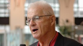 Paul Wiggin, defensive tackle for Stanford 1954-56, talks to a local radio station at a reception for players being enshrined into the College Football Hall of Fame, Aug. 10, 2006, in South Bend, Ind.