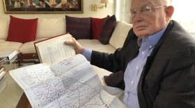 Attorney Emmet Bondurant holds a map of Georgia's congressional districts around the early 1960s, exhibit #9 in the <em>Wesberry v. Sanders </em>case he argued before the Supreme Court as a young lawyer.