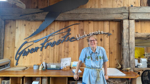 Sandra Grahl stands in the Benzie County studio of the late artist Gwen Frostic. (Photo: Natalie Reitz / Transom Story Workshop)