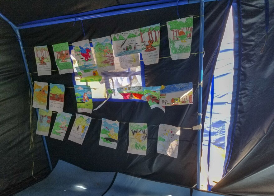 Artwork by children evacuated from the earthquake and tsunami hangs in an encampment run by Save the Children and UNICEF in Palu, Indonesia.
