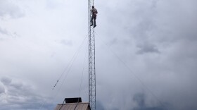 Volunteer Eric McGregor scales Weber Canyon's new radio tower to unhook a winch cable after it was installed May 13, 2026.