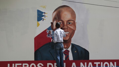 FILE - Artists paint a portrait of slain Haitian President Jovenel Moise near the presidencial residence where he was assassinated two years ago in the Petion-ville area of Port-au-Prince, Haiti, July 7, 2023.