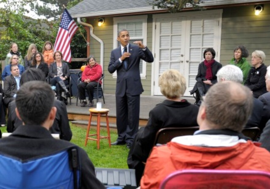 The President speaks Thursday morning in a Wedgwood neighborhood backyard in northeast Seattle. The conversation: women, jobs and the economy - and the Top Pot Doughnuts Mr. Obama brought with him.