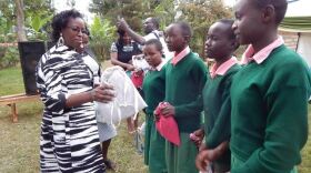 Lucy Ragwa, the wife of governor Samuel Ragwa Mbae in Tharaka Nithi Kenya, hands out Days for Girls International Hygiene Kits to students. Photo submitted by