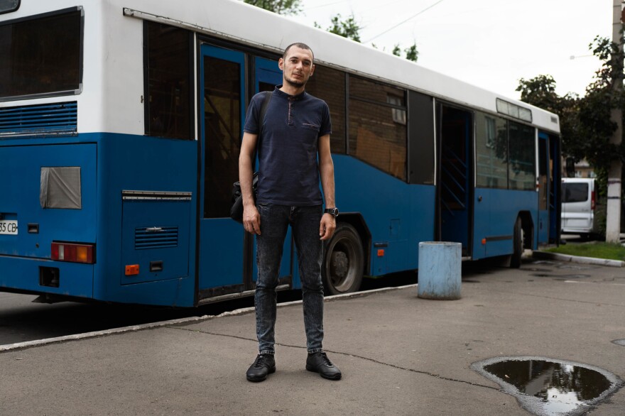 Valerie Ivaniv stands at a bus station in Pokrovsk, near the front lines and the Russian-backed separatist Donetsk region, where he waits for a bus to pick him up for a 12-hour shift at the mine.