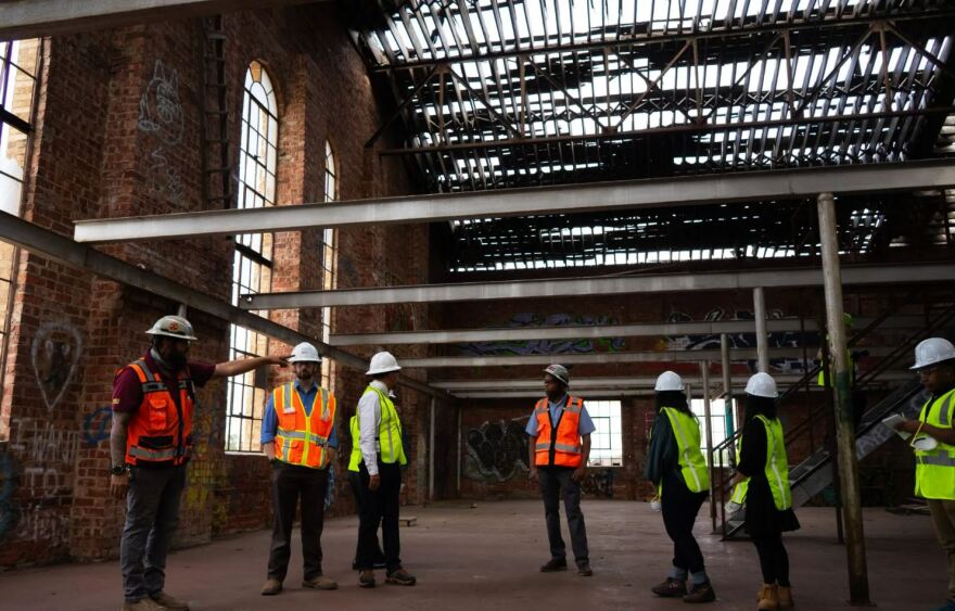 Members of Transform 1012 walk through the building at 1012 N. Main St. as it undergoes demolition Aug. 26, 2025. The building will be transformed into an arts hub.