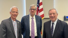 Three men in suit coats. Two of them have ties. They are from left to right, Normal Town Council member Kevin McCarthy, Normal Mayor Chris Koos and U.S. Senator Dick Durbin.