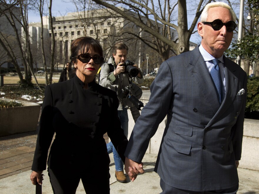 Roger Stone, accompanied by his wife, Nydia, arrives at federal court in Washington, D.C., on Thursday. The former campaign adviser for President Trump has been forbidden to speak publicly about his case.