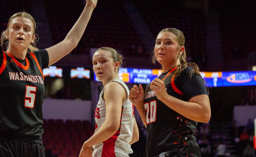 Girls high school basketball players inside an arena