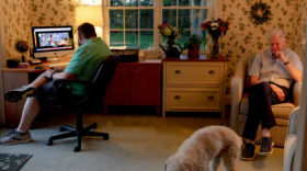 Brendan Kearney, 33, left, John Kearney, 70, and their dog Maddie spend the evening together. Brendan recently moved out to a nearby house to live a more independent life. "I think every caregiver worries about what happens when I'm not capable of providing," John said.