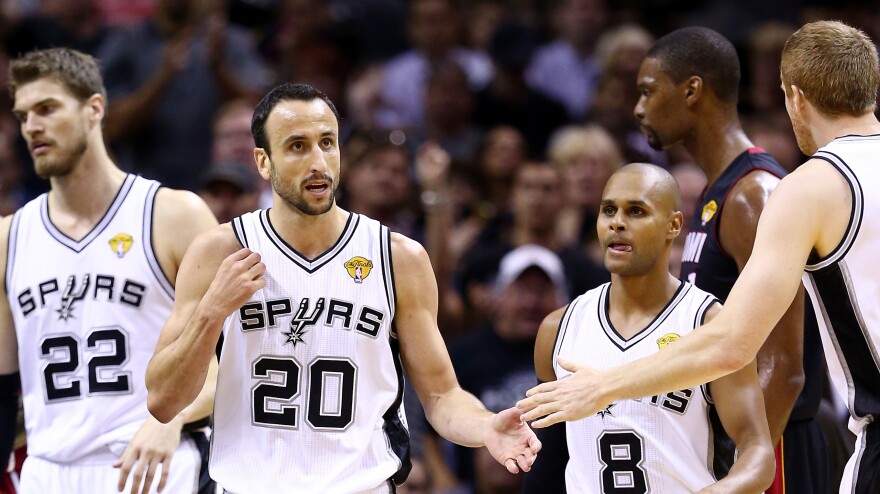 Manu Ginobili (#20) celebrates with Matt Bonner (#15) of the San Antonio Spurs against the Miami Heat during Game 5 of the 2014 NBA Finals on Sunday.