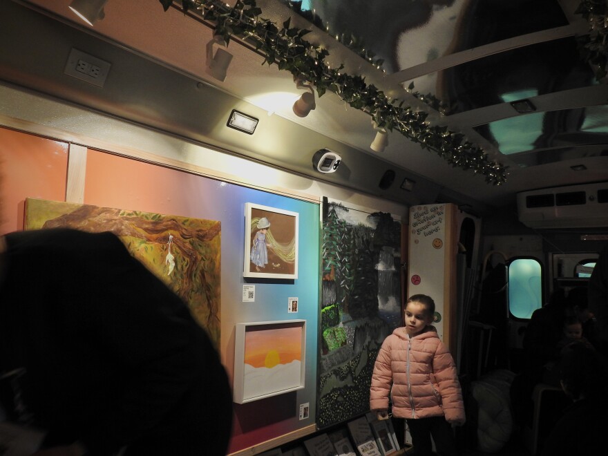 Families explore cARTie, the mobile museum art bus. Shelton, Conn.