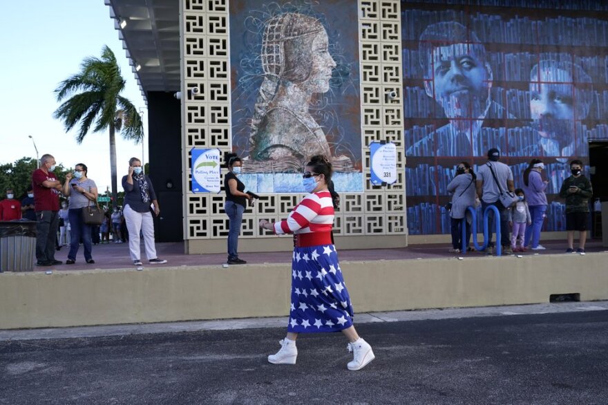 Yanitza Martinez wears red, white, and blue as she arrives to vote outside of the John F. Kennedy Library during the general election Nov. 3, 2020, in Hialeah, Fla. 