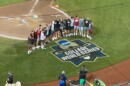 Members of the NC State baseball team gather to take a photo on the College World Series field.