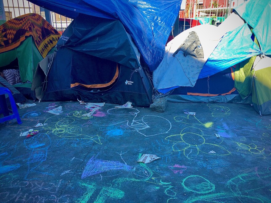 Children's artwork adds color to a tent encampment near the Paso del Norte International Bridge.