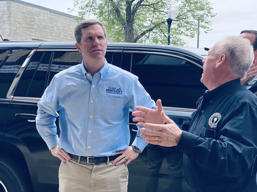 Gov. Andy Beshear stands outside the Woody Winfree Fire and Transportation Museum at Mayor James R. Knight Jr. describes damages to building sustained in the March 31 storm.