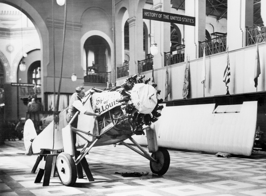 In 1928, when Charles Lindbergh gave his Spirit of St. Louis to the Smithsonian, it was first displayed in the Arts and Industries Building. Here a Smithsonian worker reassembles the plane near the building's rotunda.