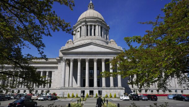  A person walks near the Legislative Building, Wednesday, April 21, 2021, at the Capitol in Olympia, Wash. 