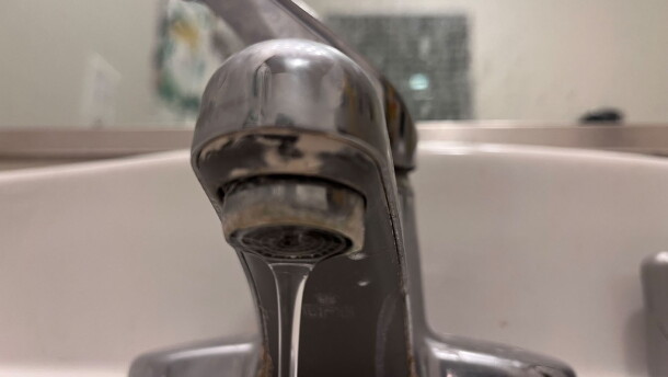 Water flows from a faucet.