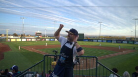 Erik the Peanut Guy in the stands behind home plate at Gesa Stadium pumping up the crowd.