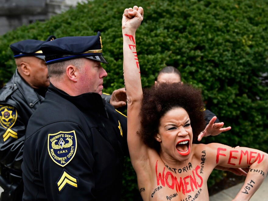 Actress Nicolle Rochelle, who appeared on several episodes of <em>The Cosby Show</em>, is detained as Bill Cosby arrives for his sexual assault trial at the Montgomery County Courthouse, on Monday.
