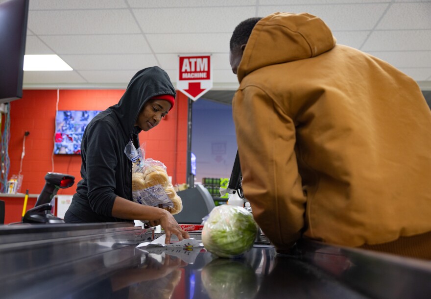 Clarissa Dossie, 32, checks out a customer using a gift certificate in November.