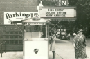 Image of the Irvin Theater in Bloomington. A woman buys popcorn from the stand outside. Another older woman in a long dress and hat walks by. The marquee sign is for Bing Crosby "Dr Rhythm" and Mary Carlisle.