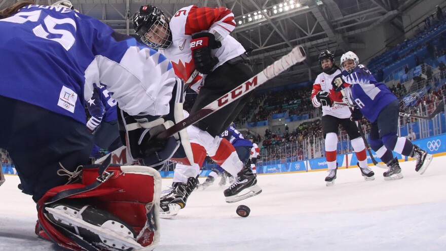 Canada's Jennifer Wakefield tries to get the puck past USA's goalie Maddie Rooney in the women's gold medal ice hockey match between Canada and the U.S. at the Pyeongchang 2018 Winter Olympic Games.