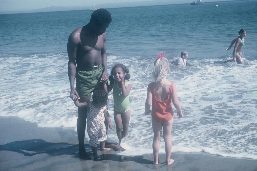 Akpem's father and sisters on the beach in California with cousins.