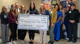 The St. Joseph Memorial Hospital Mission and Values Team displays the money it raised for the local food pantry.