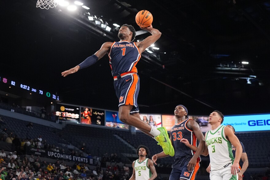Auburn guard Kevin Overton (1) sails to the basket to score against Oregon during the second half of an NCAA college basketball game in Las Vegas, Monday, Nov. 24, 2025.