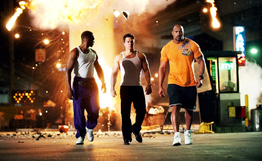 <strong>The Bang-Bang Club:</strong> <em>Pain & Gain,</em> with Anthony Mackie, Mark Wahlberg and Dwayne Johnson as three guys on a heist, is a coulda-been-nimble caper that got Michael Bay-ified on the way to the multiplex.