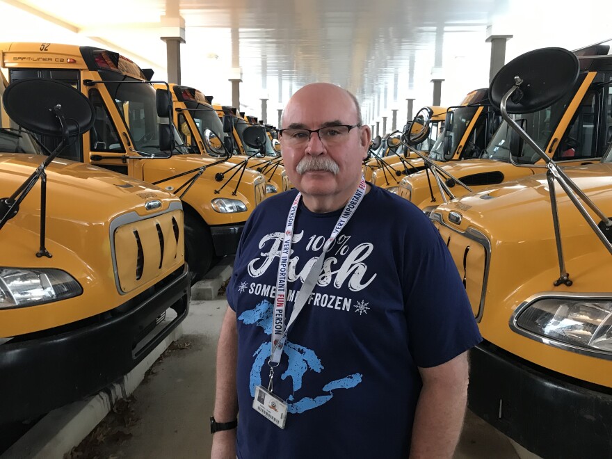 man standing near buses