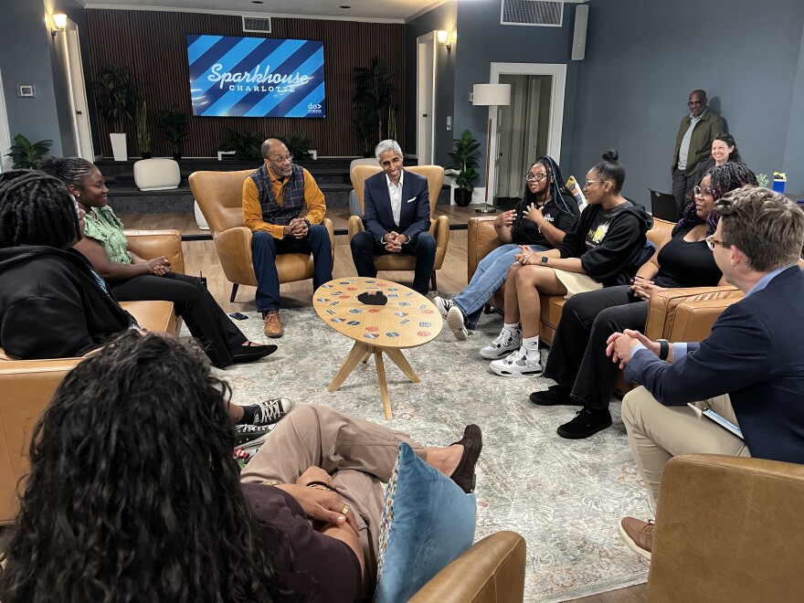 Former U.S Surgeon General Dr. Vivek Murthy sits with a group of high school students in west Charlotte, talking about address lonelines and isolation.