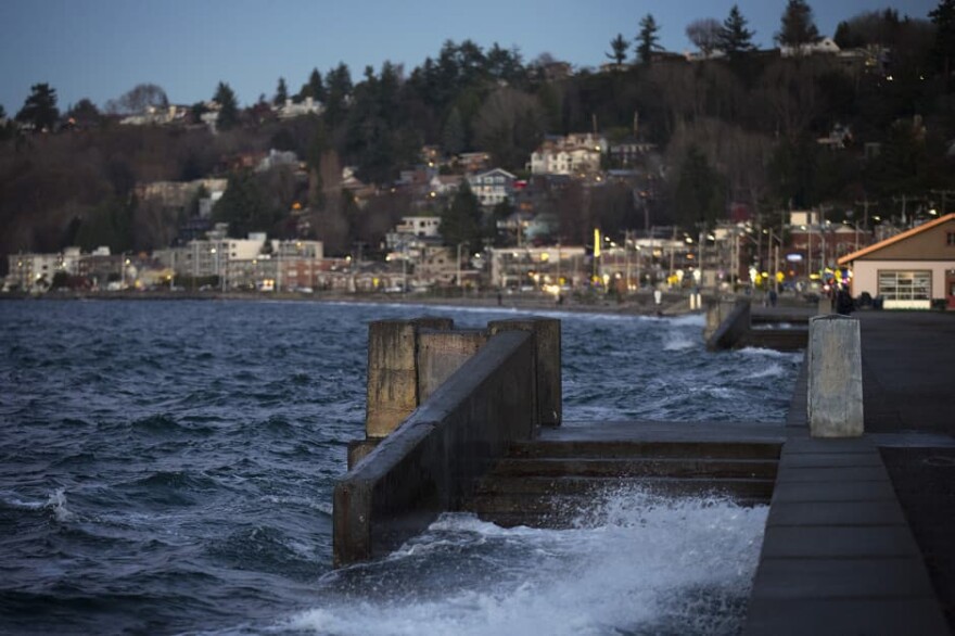 Water spills over a set of stairs that typically lead to the beach during a King Tide at Alki Beach Park on Tuesday, Dec. 5, 2017, in West Seattle. (Megan Farmer/KUOW)
