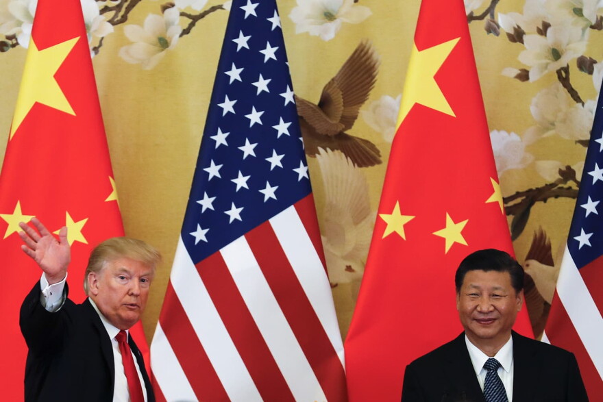U.S. President Donald Trump waves next to Chinese President Xi Jinping in Beijing. (Andy Wong/AP)