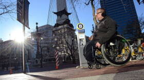 Richard Propes on lap 77 of 122 around Monument Circle on Saturday, Jan. 2, 2016 in his wheelchair to draw attention to the problem of violence against children.