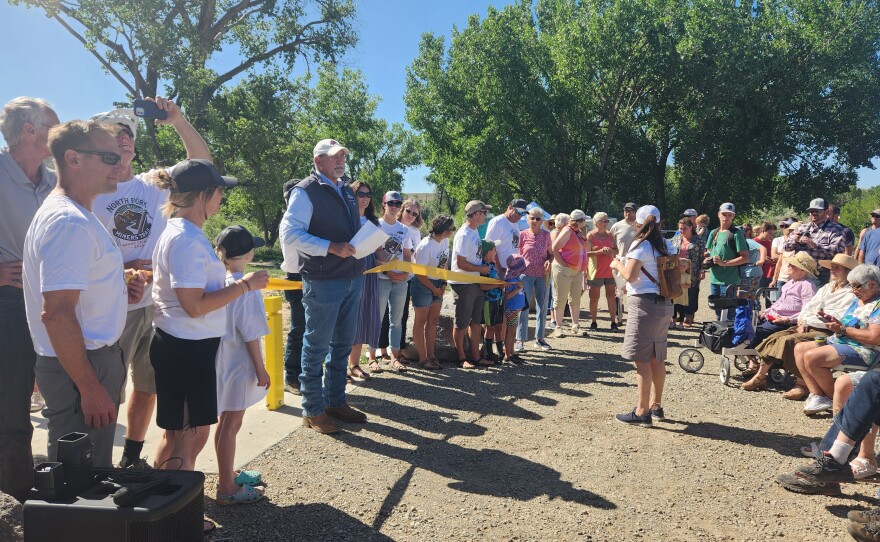 Wendell Koontz, Delta County Commissioner, prepares for the ribbon cutting ceremony for the grand opening
