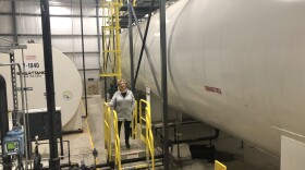 Northeast Biodiesel President Lynn Benander stands next to a tank that will hold 50,000 gallons of finished fuel in Greenfield, Massachusetts, on September 26, 2022.