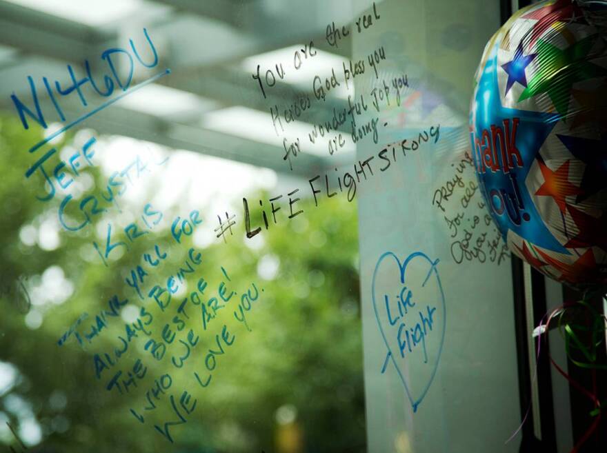 Duke community members leave messages on a memorial wall in Duke Medicine Pavilion.