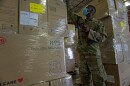 Military personnel stock Personal Protective Equipment (PPE) at the Texas Department of Emergency Management warehouse in San Antonio.