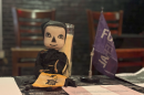 A skeleton doll and funeral flag adorn the table for information about the Cleveland Death Society. The group has hosted events like a Death Cafe - a scheduled non-profit get-together to talk about death over food and drink, usually tea and cake.