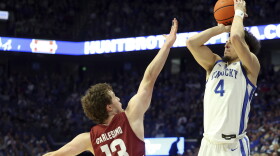 Kentucky's Koby Brea (4) shoots while pressured by Colgate's Kyle Carlesimo (13) during the first half of an NCAA college basketball game in Lexington, Ky., Wednesday, Dec. 11, 2024. (AP Photo/James Crisp)
