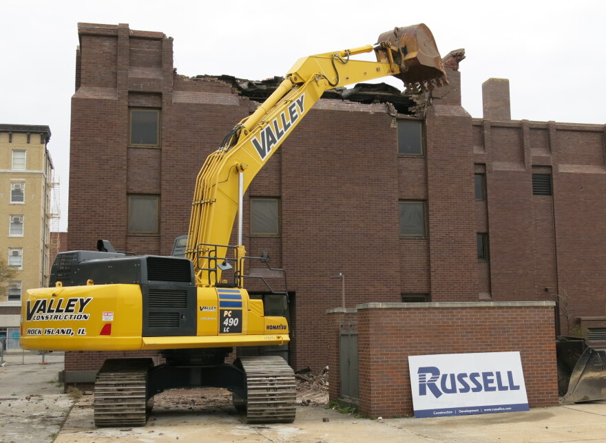 pulling down the first bricks at the former Bituminous Insurance building in downtown Rock Island