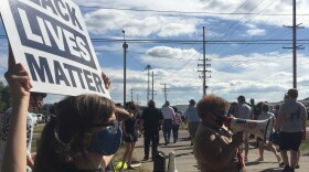 Woman holds BLM sign