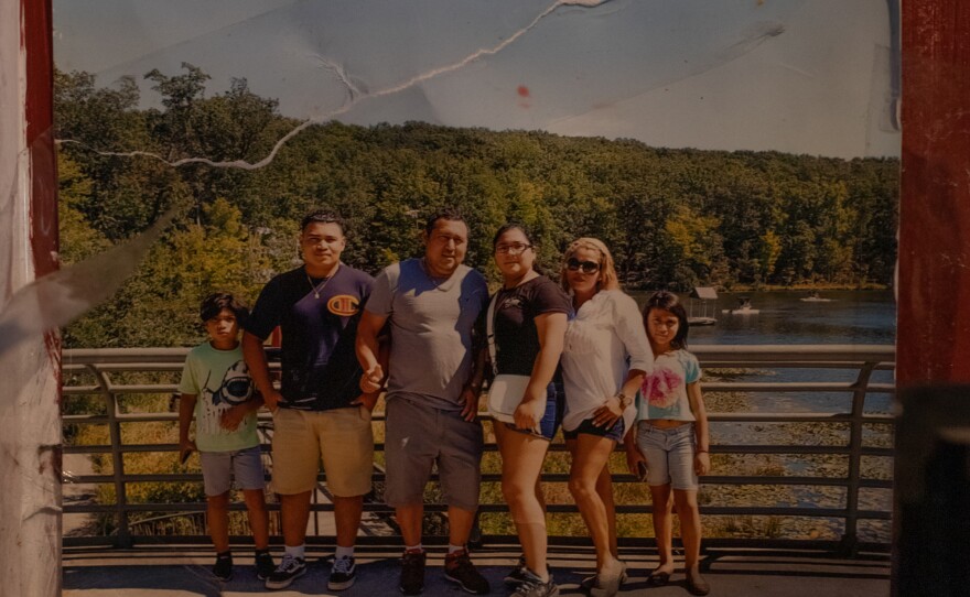 A photo of Edilberto Espinoza Sierra and his family hangs next to his bed at his family's home in Wallace on April 17, 2026. Espinoza Sierra was shot and killed by the Wilmington Police Department in the early morning hours of March 8 following an incident in a downtown Wilmington parking garage. Espinoza Sierra was incorrectly identified as a suspect before he was killed and now his family is seeking answer and accountability.